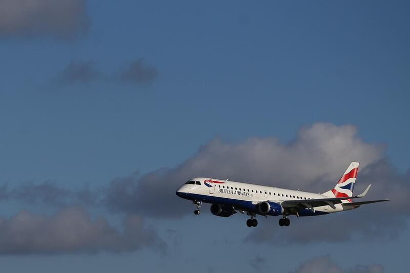 (FILES) In this file photo taken on October 27, 2017 A British Airways E190 Embraer airplane lands at London City Airport in London on October  27, 2017.  Rising effective fuel costs helped push operating profits lower at British Airways parent company IAG in the first half of 2019, although the group managed to increase revenue from passengers despite intense competition in the industry.
 / AFP / Daniel LEAL-OLIVAS
