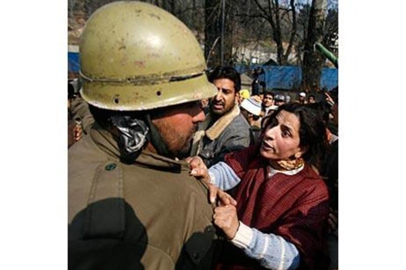 A Kashmiri Muslim woman argues with an Indian policeman during a protest over the killing of a 16-year-old student in Srinagar, one of about 100,000 people killed since the start of the insurgency in 1989.