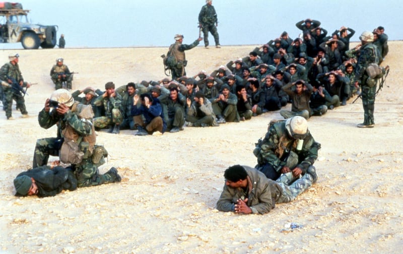 Iraqi prisoners of war sit in circles somewhere in the Saudi Arabian desert after giving themselves up to US troops in 1991. (AP Photo/Tannen Maury)