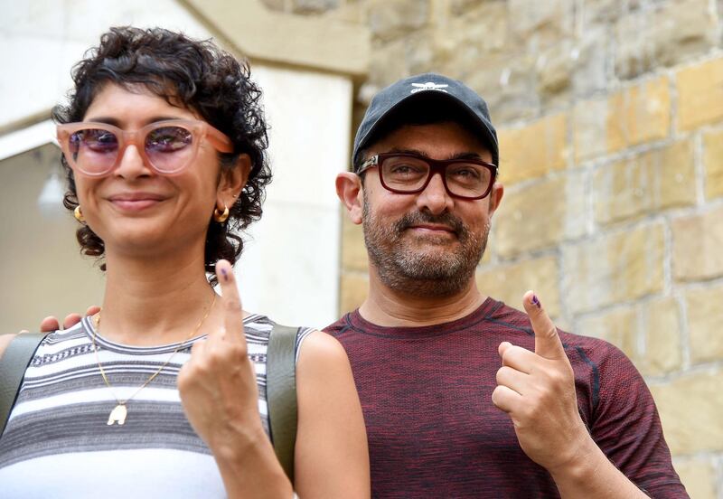 Indian Bollywood actor Aamir Khan and wife, director Kiran Rao, pose for photographs after casting their vote at a polling station in Mumbai on April 29, 2019. AFP