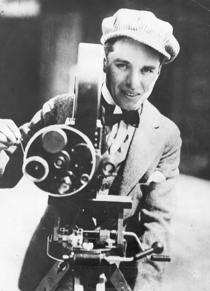 Charlie Chaplin (1889 - 1977), English film actor and director operating a movie camera.  Original Publication: People Disc - HW0474   (Photo by Keystone/Getty Images)