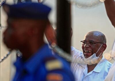 Sudan's ousted president Omar al-Bashir gestures during his trial in the capital Khartoum on October 20, 2020, along with 27 co-accused over the 1989 military coup that brought him to power. The trial of Sudan's ousted president Omar al-Bashir and others over a 1989 coup heard defence arguments, dismissing charges of illegal use of military force. The latest hearing coincided with a mission to Khartoum by a team from the International Criminal Court (ICC), which has sought for almost a decade to try Bashir for alleged war crimes in Darfur. It was held as Sudan celebrated a US decision to remove the country from Washington's blacklist of state sponsors of terrorism. 
 / AFP / Ebrahim HAMID
