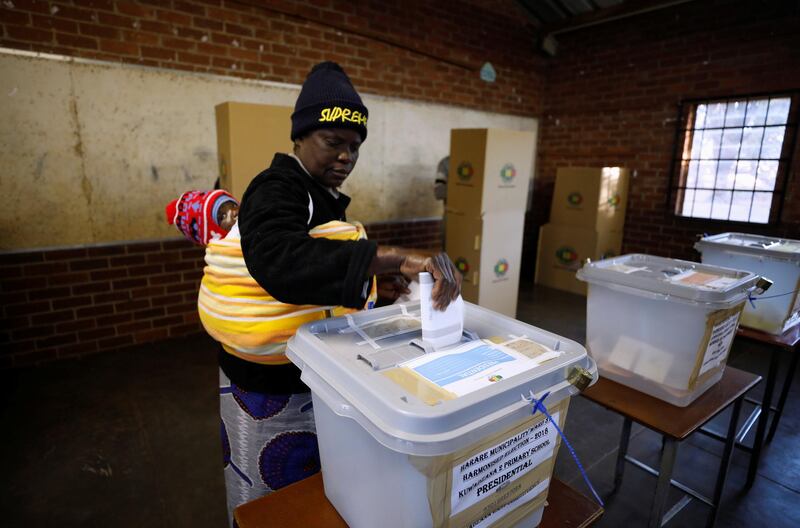 A Zimbabwean voter casts her ballot in the country's general elections in Harare, Zimbabwe. REUTERS / Mike Hutchings