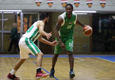 Baghdad's Oil Club guard DeMario Mayfield (R) brings the ball up the court during a basketball match against Iraq's Airline Club, in Baghdad on December 7, 2017.
DeMario Mayfield feared it was the end of his basketball career when he was arrested for planning a robbery, but the former US college star is bouncing back -- in war-torn Iraq. 

Originally from Georgia in America's deep south, the 6 foot five inch (1.95 metre) player is now leading Iraq's national team after taking citizenship following a 2015 club move to Baghdad. / AFP PHOTO / Ahmad al-Rubaye