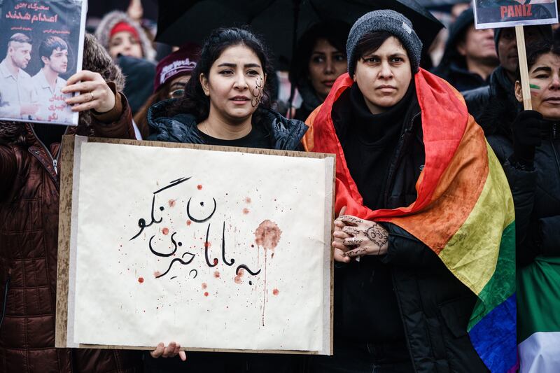 A woman in Berlin with a sign reading 'don't tell mama', a quote from one of the executed Iranian protesters. EPA