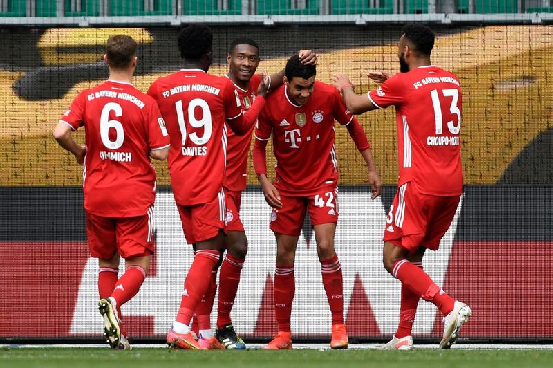 amal Musiala, second right, celebrates after scoring Bayern Munich's third goal in their 3-2 win at Wolfsburg on Saturday, April 17. AFP