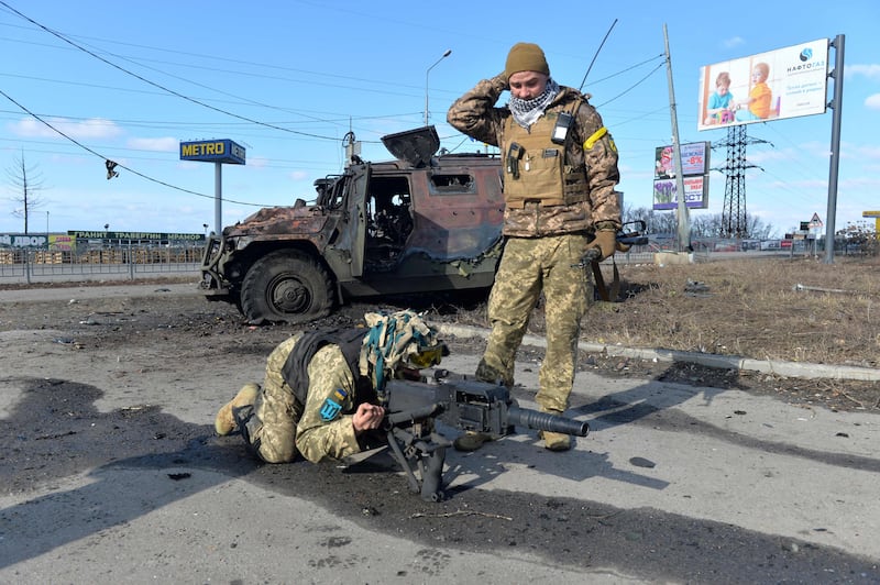 Ukrainian Territorial Defence fighters test an automatic grenade launcher taken from a destroyed Russian infantry mobility vehicla after a battle in Kharkiv. AFP