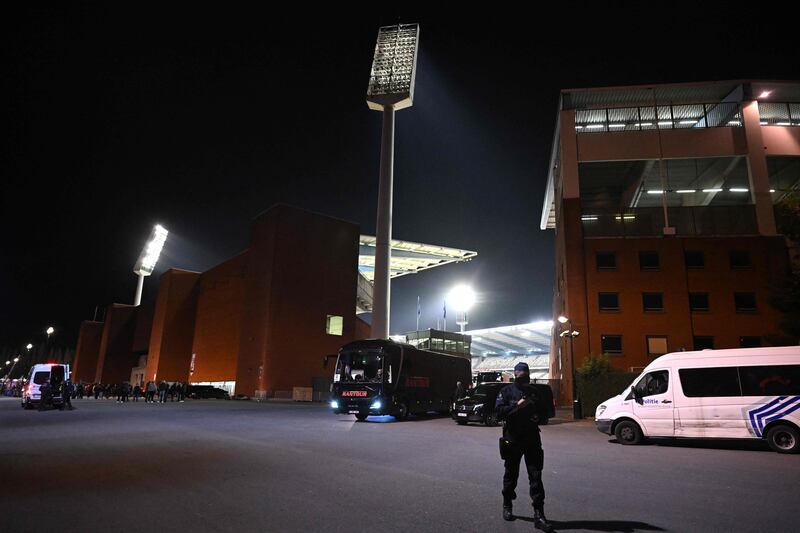 A police officer stand guards outside the King Baudouin Stadium, where Belgium v Sweden was abandoned at half-time once news of the fatal shooting had filtered through. AFP