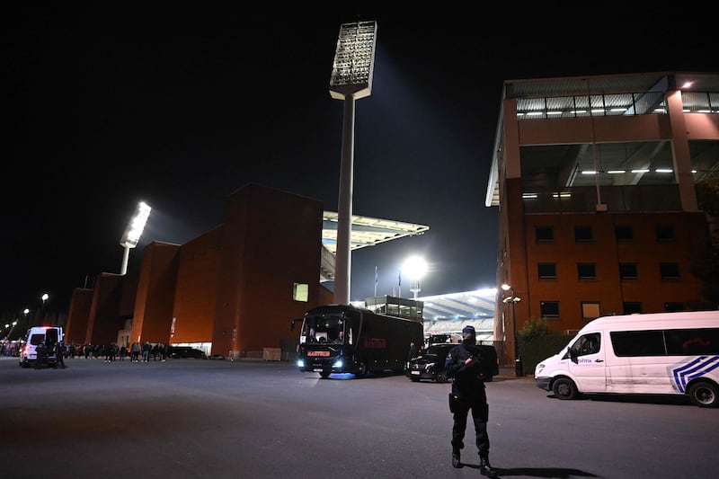 A police officer stand guards outside the King Baudouin Stadium, where Belgium v Sweden was abandoned at half-time once news of the fatal shooting had filtered through. AFP