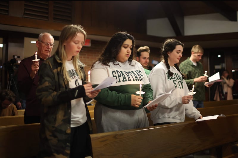 Michigan State University students and others attend a prayer service. AFP