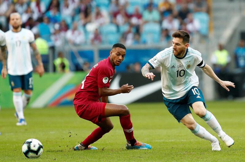 Qatar's Salem Al Hajri, leftm watches as Argentina's Lionel Messi dribbles past him. Argentina won the Group B match 2-0 at Arena do Gremio Stadium in Porto Alegre to advance to the quarter-finals of the 2019 Copa America. EPA