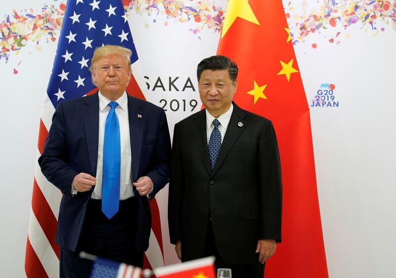 FILE PHOTO: U.S. President Donald Trump and China's President Xi Jinping pose for a photo ahead of their bilateral meeting during the G20 leaders summit in Osaka, Japan, June 29, 2019. REUTERS/Kevin Lamarque/File Photo