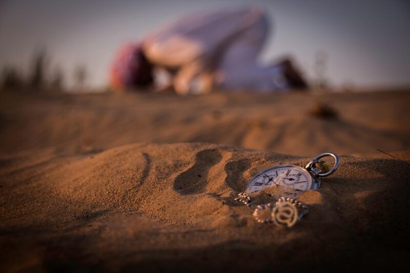 Image 2: Fatma's brother in law praying at the desert in Al Khawaneej.  

For Arts & Life.  Story by Maey El Shoush. 

Photo courtesy Fatma Al Hashemi