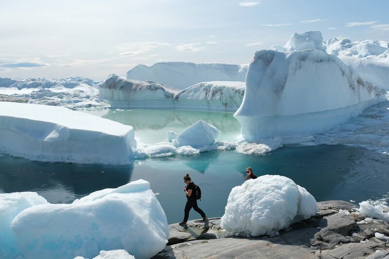 Visitors walk among free-floating ice jammed into the Ilulissat Icefjord during unseasonably warm weather in summer 2019 near Ilulissat, Greenland. Getty Images