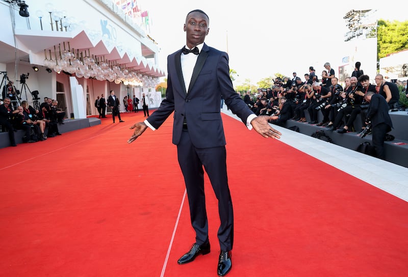 TikTok star Khaby Lame wears a midnight blue suit on the 'Il Signore Delle Formiche' red carpet. Getty