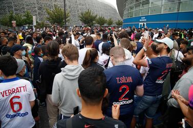 People gather outside the Parc des Princes stadium in Paris as Argentinian football player Lionel Messi is expected to arrive on August 9, 2021, a day after the 34-year-old told at his tearful farewell news conference in Barcelona that joining French football club Paris Saint-Germain was a "possibility.  (Photo by Zakaria ABDELKAFI  /  AFP)