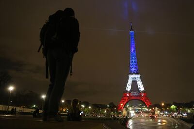 (FILES) In this file photo taken on November 16, 2015, in Paris, the Eiffel Tower is illuminated with the colors of the French flag, in tribute to the victims of the November 13 Paris terror attacks. Kurdish-led forces announced on March 23, 2019 they had fully captured the Islamic State group's last bastion in eastern Syria and declared the total elimination of the jihadists' "caliphate". / AFP / Ludovic MARIN
