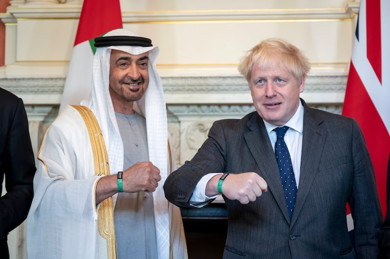 Sheikh Mohamed bin Zayed and Prime Minister Boris Johnson wear EXPO 2020 wristbands during a reception at 10 Downing Street. Ministry of Presidential Affairs