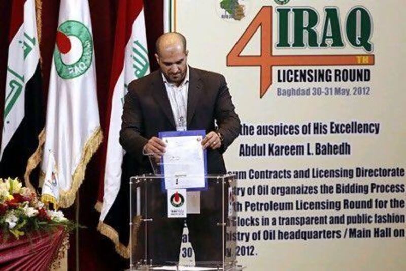 Ahmed Haider Ahmed, business development manager of Kuwait Energy, drops his offer in a box during the fourth licensing round for exploration blocks at the Iraq Oil Ministry's headquarters in Baghdad. Reuters