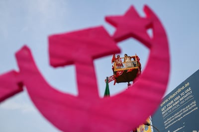 Standing on a crane behind a large symbol of Communist Party of India (Marxist), Left Democratic Front candidate K J Shine addresses supporters as campaigning ends for the second phase of polling of India's national election in Kochi, Kerala, India, Wednesday, April 24, 2024.  (AP)