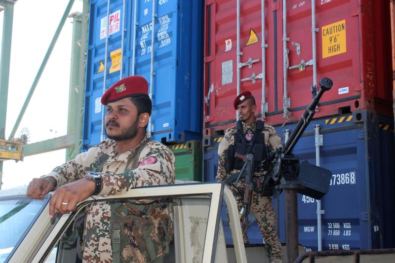 Yemeni soldiers loyal to the Saudi-backed government stand on guard at the port of Aden on December 12, 2018, during a ceremony handing over cranes from Saudi Arabia.  / AFP / Saleh Al-OBEIDI

