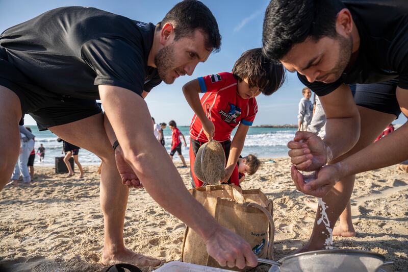 Volunteers from Pirates Surf club help to gather up thousands of tiny plastic pellets known as nurdles. All photos: Pirates Surf