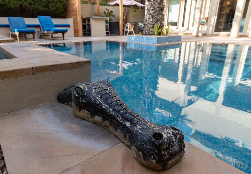 Emma and Kristian Barber's back garden pool features sculptures and also has a Jacuzzi