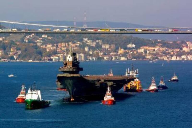 epa02861545 (FILE) The Chinese aircraft carrier 'Varyag' passes Bosporus bridge in Istanbul, Turkey, on 01 November 2001. The giant 306-metre (1,000-foot) decomissioned ship was bought from Ukraine by a Macau-based company which had plans to convert it into a floating hotel and casino. China‘s first aircraft carrier left its shipyard in the northeastern province of Liaoning on 10 August 2011 for its maiden sea trial according to news reports. The vessel, refitted from a hull bought from Ukraine, was destined for 'technical research, experiments and training,' the Defence Ministry said in July.  EPA/KERIM OKTEN *** Local Caption ***  02861545.jpg