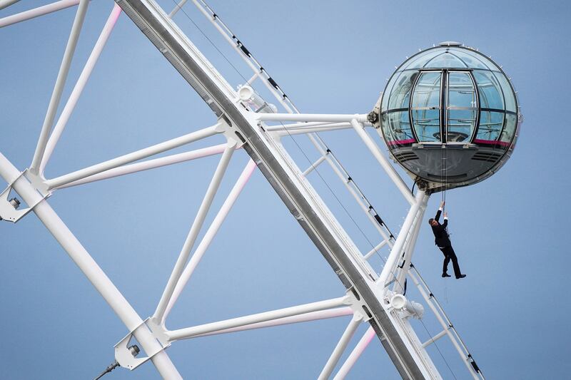 A man dressed as James Bond performs a stunt on the London Eye before the world premiere of 'No Time To Die'. Photo: AP