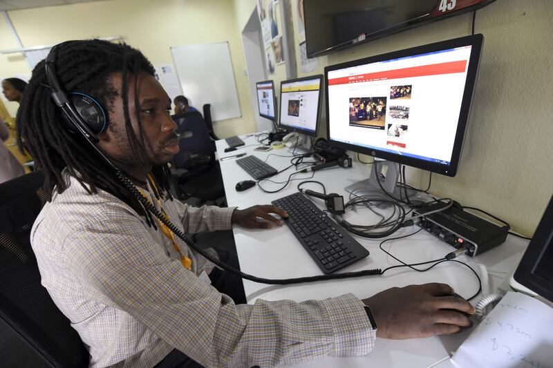 A British Broadcasting Corporation (BBC) programmer Busayo Iruemiode checks a website in Pidgin in Lagos, on August 18, 2017. 
On August 21, 2017 the British media giant will launch an online portal that will be entirely in Pidgin and feature text news, features and podcasts. Pidgin takes inspiration from Portuguese, the first European language to reach Nigeria's shores, English, the enduring colonial-era language, as well as Jamaican patois imported by former slaves returning to the continent. The language has shifted and evolved uninterrupted since its inception. / AFP PHOTO / AMELIE QUERFURTH