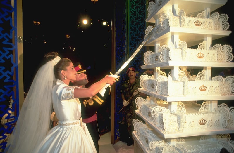 Prince Abdullah and his bride cut their elaborate cake. Getty Images