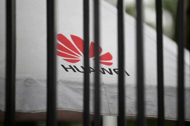 A Huawei logo is seen through the fence of its headquarters in Shenzhen, China. Reuters