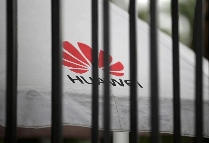 FILE PHOTO: A Huawei logo is seen outside the fence at its headquarters in Shenzhen, Guangdong province, China May 29, 2019. REUTERS/Jason Lee/File Photo