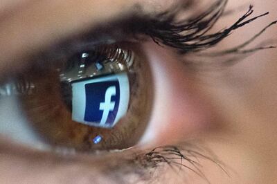 (FILES) In this file photo taken on March 22, 2018 An illustration picture taken on March 22, 2018 in Paris shows a close-up of the Facebook logo in the eye of an AFP collaborator posing while she looks at a flipped logo of Facebook.  Facebook, under pressure to ramp up privacy rules across its platform, said on August 20, 2019 it was rolling out a tool allowing users to control data that it receives from other apps and websites about their online activity. The new tool is to give clients access to their so-called "off-Facebook activity" -- fed back to Facebook with the aim of targeting advertisements -- and give them the option of deleting it. / AFP / Christophe SIMON
