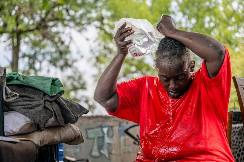 Andrea Washington pours water on herself in the Hungry Hill neighbourhood of Austin, Texas. Getty