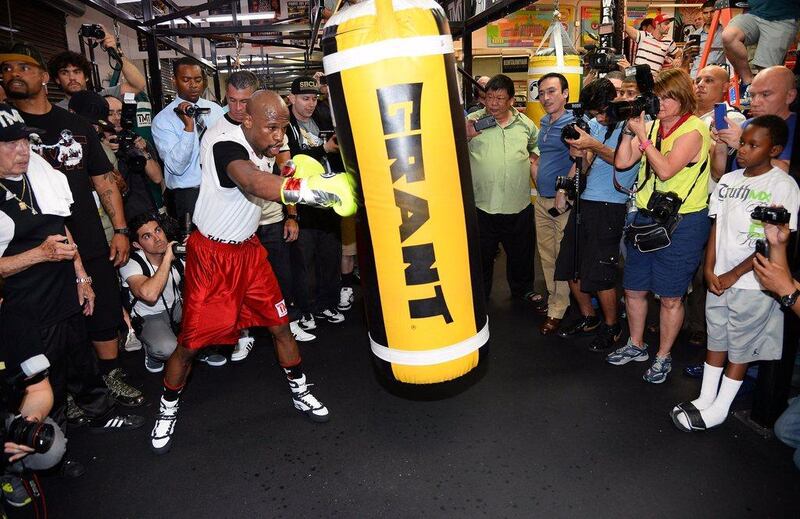 Floyd Mayweather works out with a punching bag at the Mayweather Boxing Club during his training session on Tuesday. Ethan Miller / Getty Images / AFP / April 22, 2014