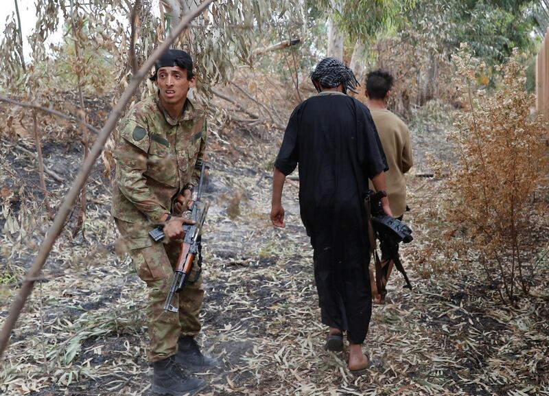 Fighters patrol near scrubland on the outskirts of Tripoli. Reuters