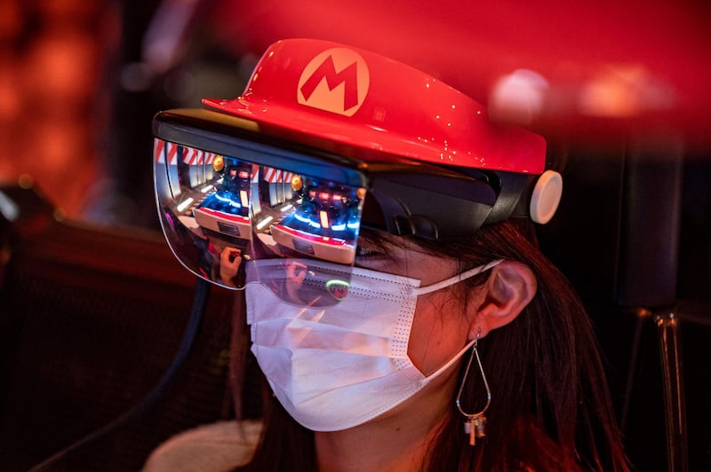 A fan of Universal Studios Japan wears themed augmented reality goggles on the Mario Kart ride. AFP