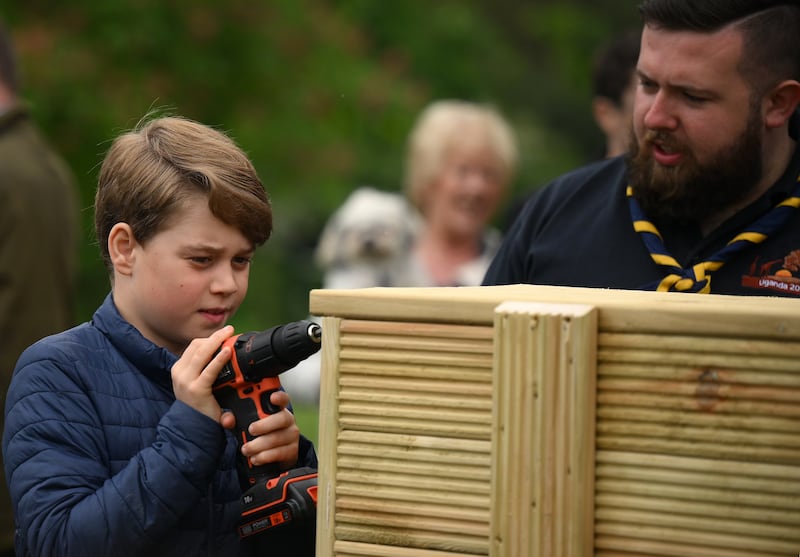 Prince George helps out with some woodwork as Britain enjoyed a bank holiday for the coronation weekend. Getty