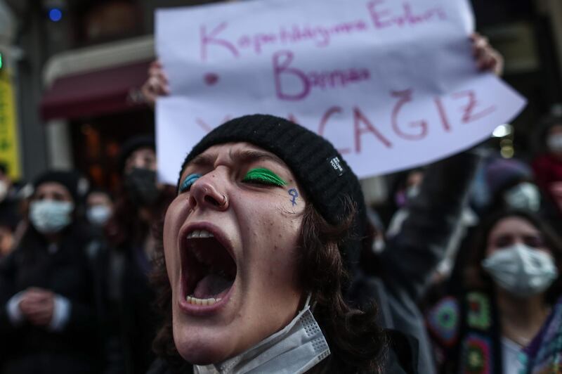epa09062498 A woman shouts slogans as she attends a rally marking the International Women's Day in Istanbul, Turkey, 08 March 2021. International Women's Day is celebrated globally on 08 March to promote women's rights and equality. According to the 'We'll Stop Femicide' social platform, 335 women were killed through gender violence and hundreds assaulted by men in 2020, in Turkey.  EPA/SEDAT SUNA