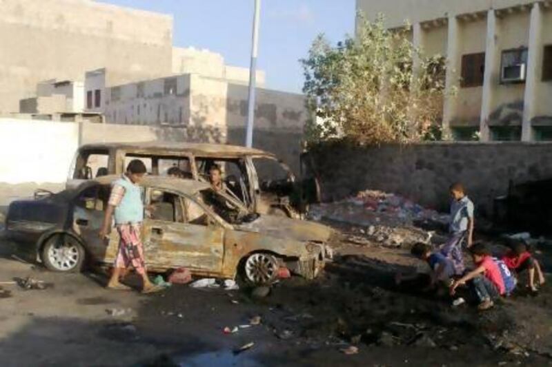 Yemeni boys gather near destroyed vehicles following clashes between security forces and southern separatists in Aden. EPA