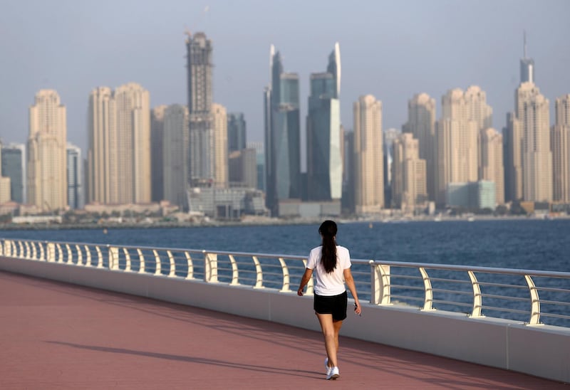 Dubai, United Arab Emirates - Reporter: N/A. News. Weather. A lady walks on the boardwalk in the summer heat. Wednesday, July 8th, 2020. The Palm, Dubai. Chris Whiteoak / The National