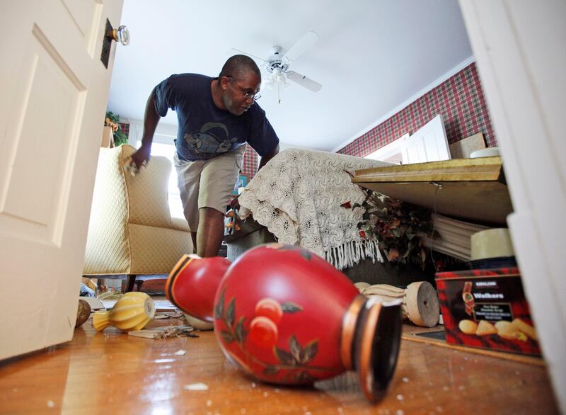 Tony Williams surveys damage at his Mineral, Va. home after an earthquake struck Tuesday, Aug. 23, 2011. Items in his home were knocked over and displaced, and the home suffered some structural damage after the most powerful earthquake to strike the East Coast in 67 years shook buildings and rattled nerves from South Carolina to New England. The quake was centered near Mineral, a small town northwest of Richmond. (AP Photo/Steve Helber) *** Local Caption ***  East Coast Quake.JPEG-0dc22.jpg