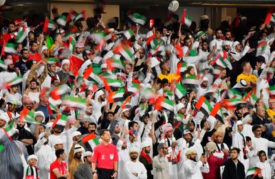 Emirati supporters wave the national flag during the 2019 AFC Asian Cup quarter-final football match between UAE and Australia at Hazaa bin Zayed Stadium in Al-Ain on January 25, 2019.  / AFP / Giuseppe CACACE
