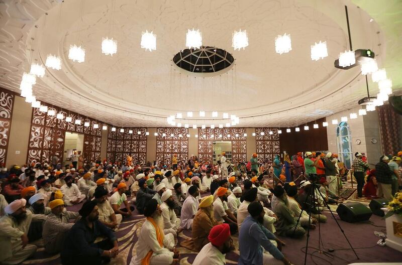 Devotees worship in the large central prayer room which houses the Guru Granth Sahib, the central religious text in Sikhism.