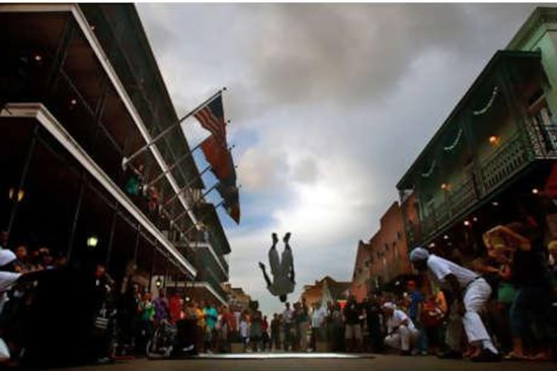 After the storm: street performers entertain an expectant crowd on Bourbon Street in the French Quarter, New Orleans.