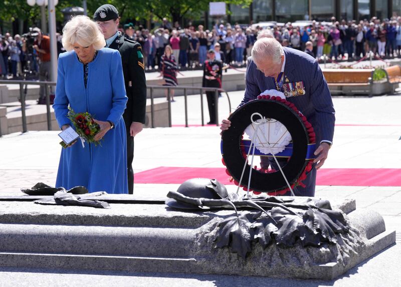 Britain's Prince Charles and Camilla, Duchess of Cornwall, lay a wreath at the National War Memorial in Ottawa on May 18, 2022. AFP