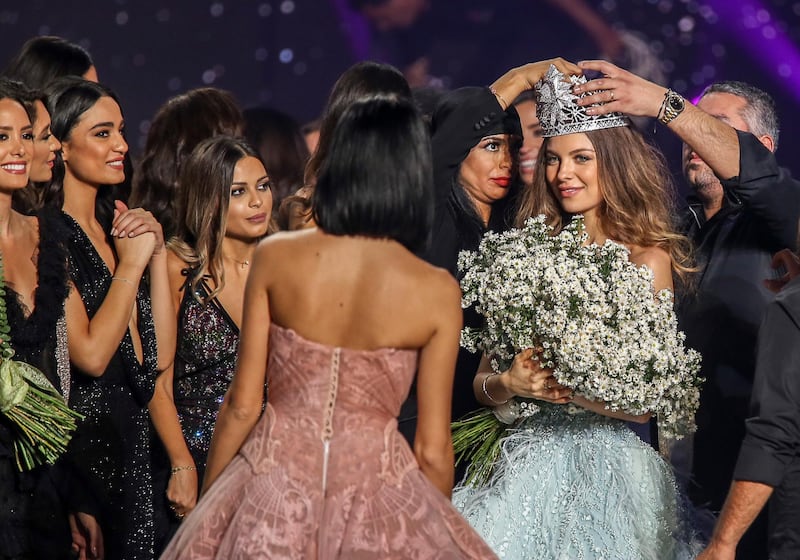 The Lebanese jeweler Dumit Zougheib , who made the crown of, places it on the head of the winner. Photo / EPA