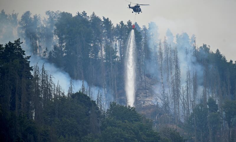 A Czech military helicopter helps to extinguish a fire close to the German-Czech border near Schmilka, Germany. Reuters