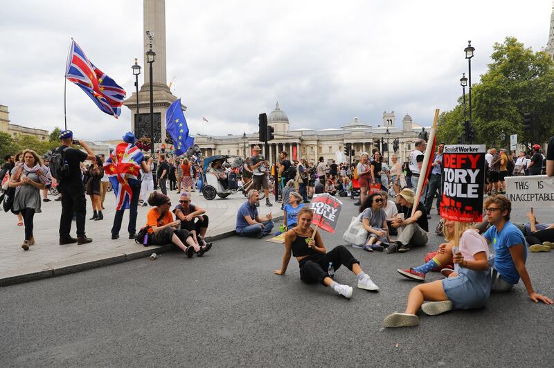 epa07807746 Anti Brexit protesters block the road and stop traffic in Trafalgar Square following a protest against Brexit and the prorogation of parliament in London, Britain, 31 August 2019. A number of 'Stop The Coup' protests are taking place across the Britain because the British government is to suspend Parliament after the summer break, a move that might block Members of Parliament from voting against a possible no-deal Brexit.  EPA/VICKIE FLORES